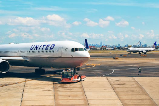 Aircraft on the runway at Newark Airport with city skyline in the background.
